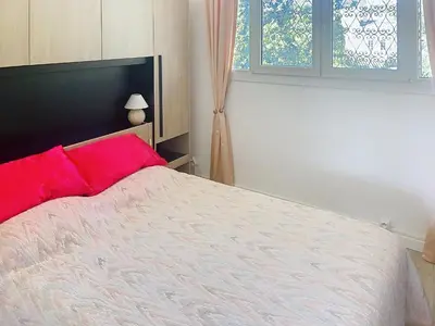 a bedroom with a large bed with red pillows at Superbe 2 pièces 344L Jol in Cannes