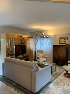a living room with a couch and a table at A 2 pas des plages du Midi, 261L DEPER in Cannes