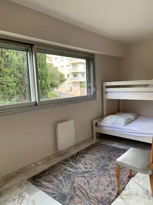 a room with two bunk beds and a window at A 2 pas des plages du Midi, 261L DEPER in Cannes