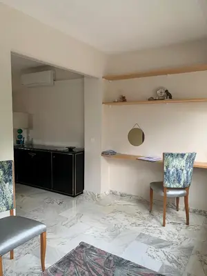 a living room with a desk and a chair at A 2 pas des plages du Midi, 261L DEPER in Cannes