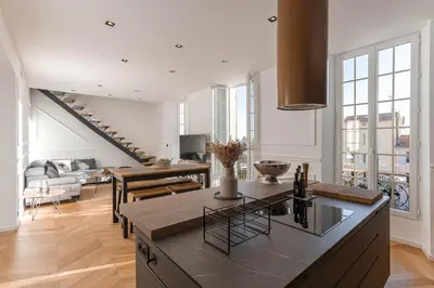 a kitchen and living room with a staircase in the background at Syssi - 3 Chambres avec salles de bains, spacieux, calme, moderne, idéal congrès in Cannes