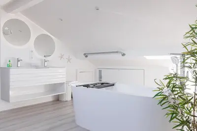 a white kitchen with a white counter and a sink at Syssi - 3 Chambres avec salles de bains, spacieux, calme, moderne, idéal congrès in Cannes