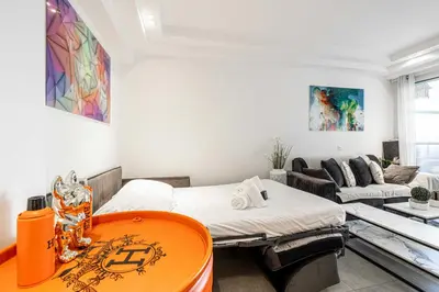 a room with two beds and a couch at Modern 1 bedrm apt with balcony - Cannes-Croisette in Cannes