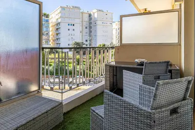a balcony with a table and chairs and a window at Modern 1 bedrm apt with balcony - Cannes-Croisette in Cannes