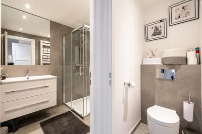 a bathroom with a shower and a toilet and a sink at Modern 1 bedrm apt with balcony - Cannes-Croisette in Cannes