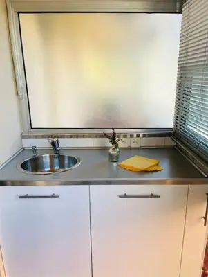 a kitchen counter with a sink and a window at Studio premium St Louis - emplacement idéal in Cannes