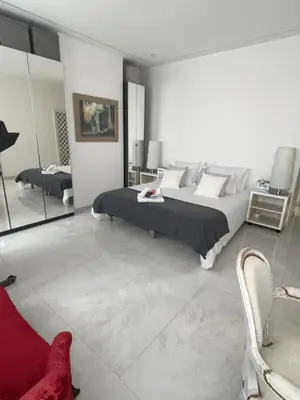 a bedroom with a large bed and a mirror at Appartement Haut Standing 5 pièces Cannes centre in Cannes