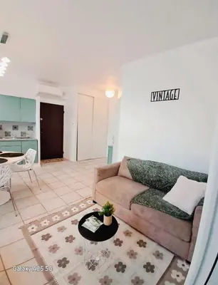 a living room with a couch and a table at Emplacement idéal 450 métres du Palais croisette plage in Cannes