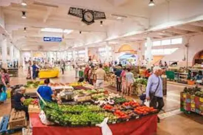 a group of people in a market with fruits and vegetables at Emplacement idéal 450 métres du Palais croisette plage in Cannes