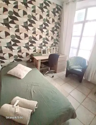 a bedroom with a green bed and a desk at Emplacement idéal 450 métres du Palais croisette plage in Cannes