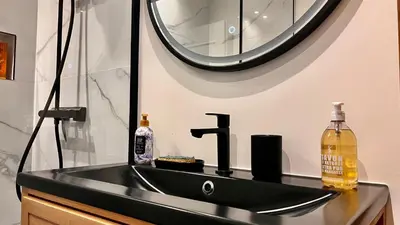 a kitchen with a counter with a microwave on it at L'Azur - Apt de Standing - Piscine - Parking in Le Cannet