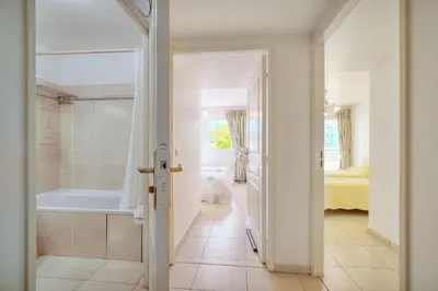 a bathroom with a bath tub and a bedroom at Spacieux 2 chambres TERRASSE, PARKING proche CENTRE VILLE A2B237 in Cannes