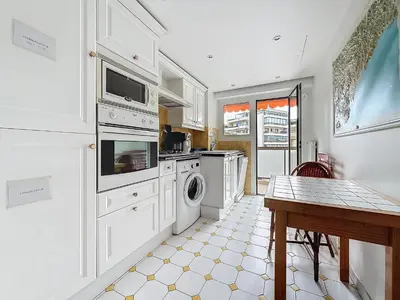 a kitchen with a washer and dryer and a table at Intuition - 2 personnes - Le Fragonard in Cannes