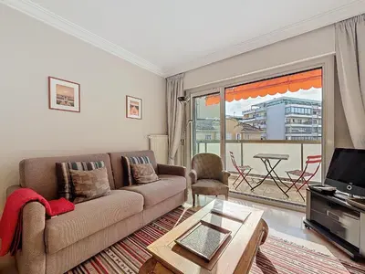 a living room with a couch and a tv at Intuition - 2 personnes - Le Fragonard in Cannes
