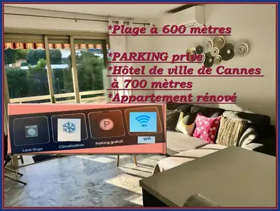 a sign in a room with a couch and a table at T2 Vallombrosa Terrasse Parking in Cannes