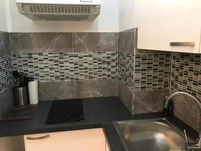 a kitchen with a sink and a counter top at T2 Vallombrosa Terrasse Parking in Cannes