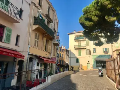 a street with buildings and a scooter parked on the street at T2 Vallombrosa Terrasse Parking in Cannes