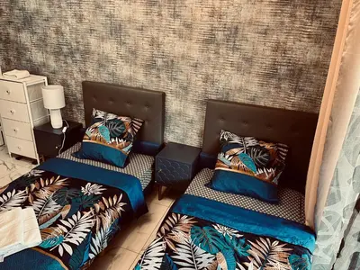 two beds sitting next to each other in a room at T2 Vallombrosa Terrasse Parking in Cannes