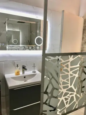 a bathroom with a sink and a mirror at T2 Vallombrosa Terrasse Parking in Cannes