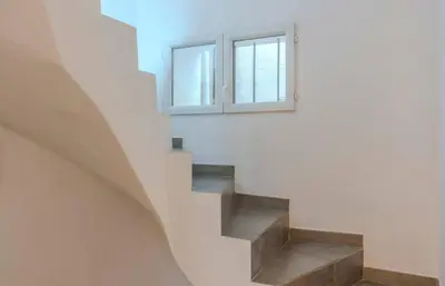 a staircase in a house with a window at Maison 4 chambres - Cannes centre -Clim WIFI 7 personnes in Cannes