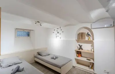 two beds in a room with white walls at Maison 4 chambres - Cannes centre -Clim WIFI 7 personnes in Cannes