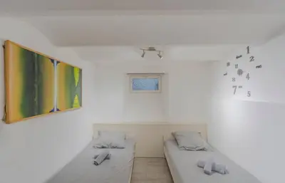 a room with two beds and a painting on the wall at Maison 4 chambres - Cannes centre -Clim WIFI 7 personnes in Cannes