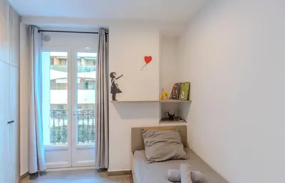 a small bedroom with a bed and a window at Maison 4 chambres - Cannes centre -Clim WIFI 7 personnes in Cannes