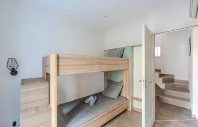 a room with two bunk beds and a staircase at Maison 4 chambres - Cannes centre -Clim WIFI 7 personnes in Cannes