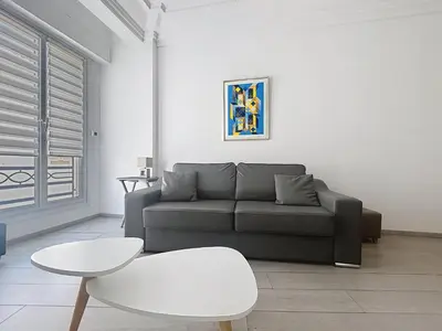 a living room with a couch and a table at Commandant André in Cannes