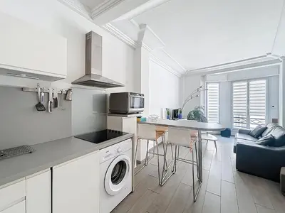 a kitchen and living room with a washer and dryer at Commandant André in Cannes