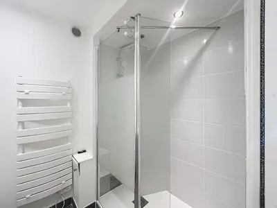 a shower with a glass door in a bathroom at Commandant André in Cannes