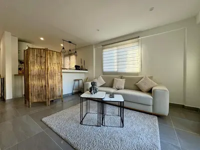 a living room with a couch and a table at Studio de 30m2 - À 5min du centre in Cannes