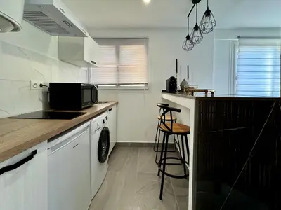 a kitchen with a counter and a sink and a microwave at Studio de 30m2 - À 5min du centre in Cannes
