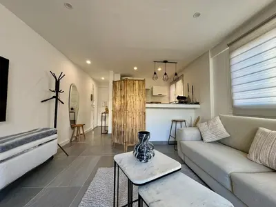 a living room with a couch and a table at Studio de 30m2 - À 5min du centre in Cannes