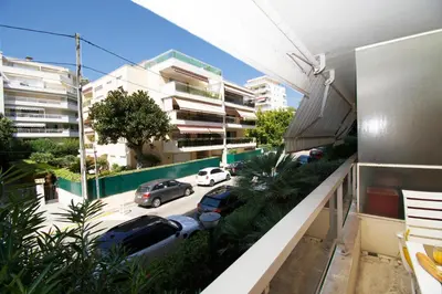an apartment balcony with cars parked in a parking lot at Le Studio Cannois Standing Presta in Cannes