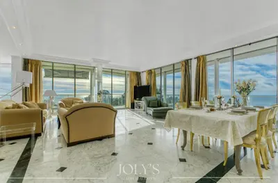 a living room with a dining room table and chairs at Villa d'architecte Super Cannes - Vue panoramique in Cannes