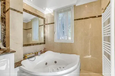 a bathroom with a large tub and a window at Villa d'architecte Super Cannes - Vue panoramique in Cannes