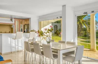 a dining room with a glass table and chairs at Villa d'architecte Super Cannes - Vue panoramique in Cannes