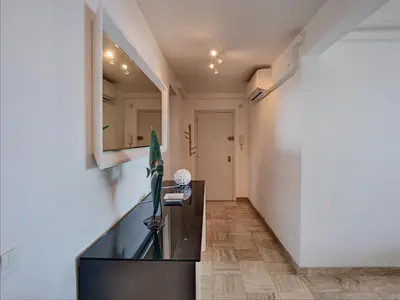 a kitchen with a black counter in a room at Belle terrasse vue mer , proche plages 223L FOV in Cannes