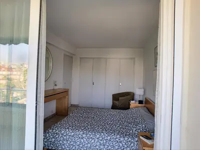 a small bedroom with a bed and a desk at Belle terrasse vue mer , proche plages 223L FOV in Cannes