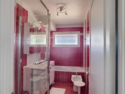 a red bathroom with a toilet and a sink at Belle terrasse vue mer , proche plages 223L FOV in Cannes