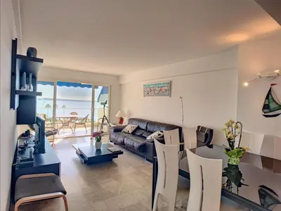 a living room with a couch and a table at Belle terrasse vue mer , proche plages 223L FOV in Cannes