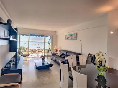 a living room with a couch and a table at Belle terrasse vue mer , proche plages 223L FOV in Cannes