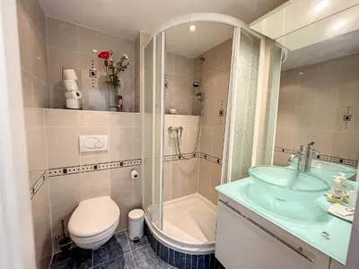 a bathroom with a sink and a toilet and a shower at Superbe 3 pièces vue mer 323L MUNAR in Cannes