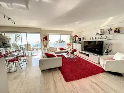 a living room with white furniture and a red rug at Superbe 3 pièces vue mer 323L MUNAR in Cannes