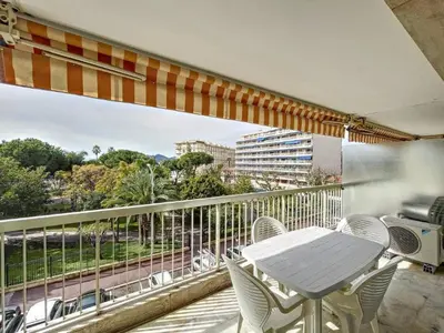 a balcony with a table and chairs on a balcony at STUDIO MIDI MAGRET Cannes in Cannes