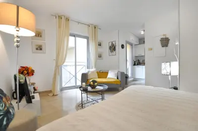 a bedroom with a bed and a living room at Nice studio for two close to the beaches of Cannes in Cannes