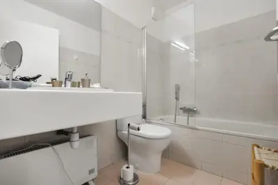a white bathroom with a toilet and a shower at Nice studio for two close to the beaches of Cannes in Cannes