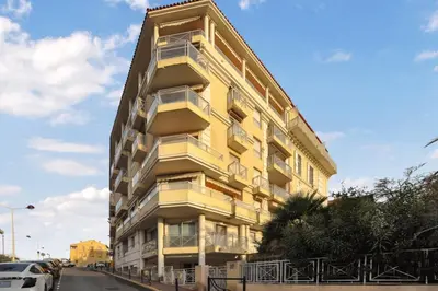 a yellow building on the side of a street at Nice studio for two close to the beaches of Cannes in Cannes