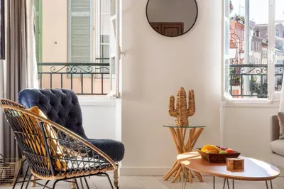a living room with a chair and a table at 3P Central Cannes Suquet in Cannes